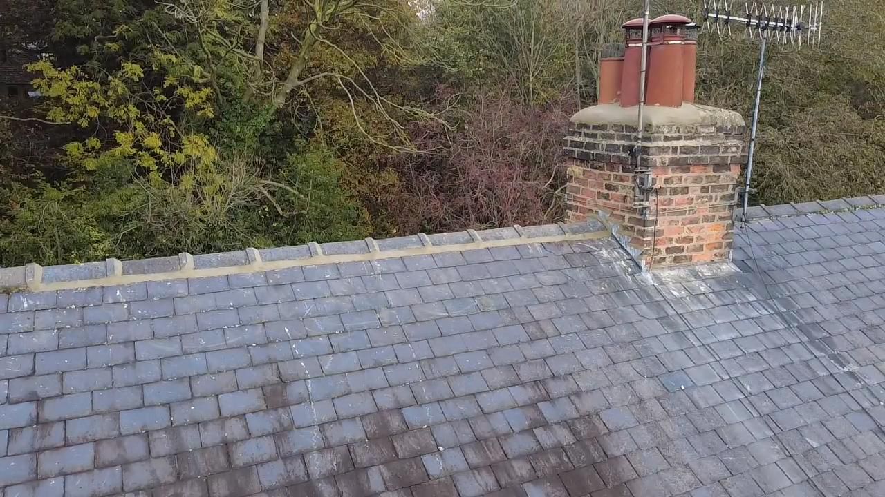 Slate roof with lead chimney flashing and ridge detail