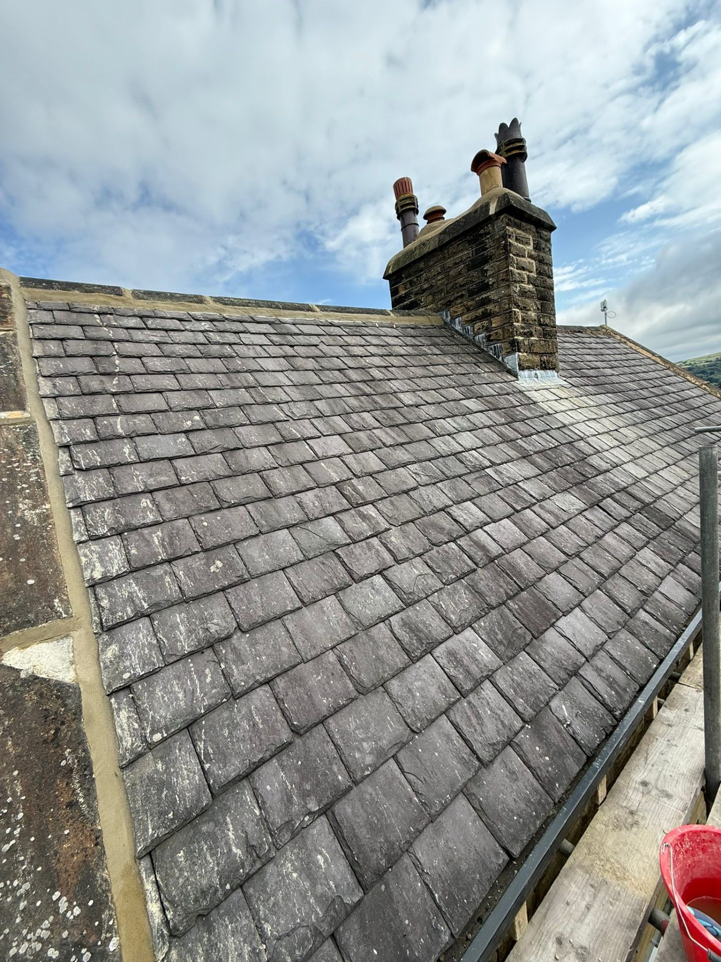 Natural slate roof with lead flashing around chimney